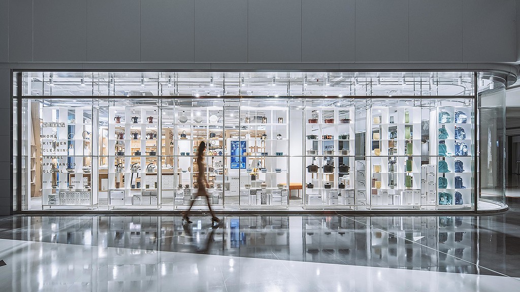 A room with a glass wall and a large display of products.